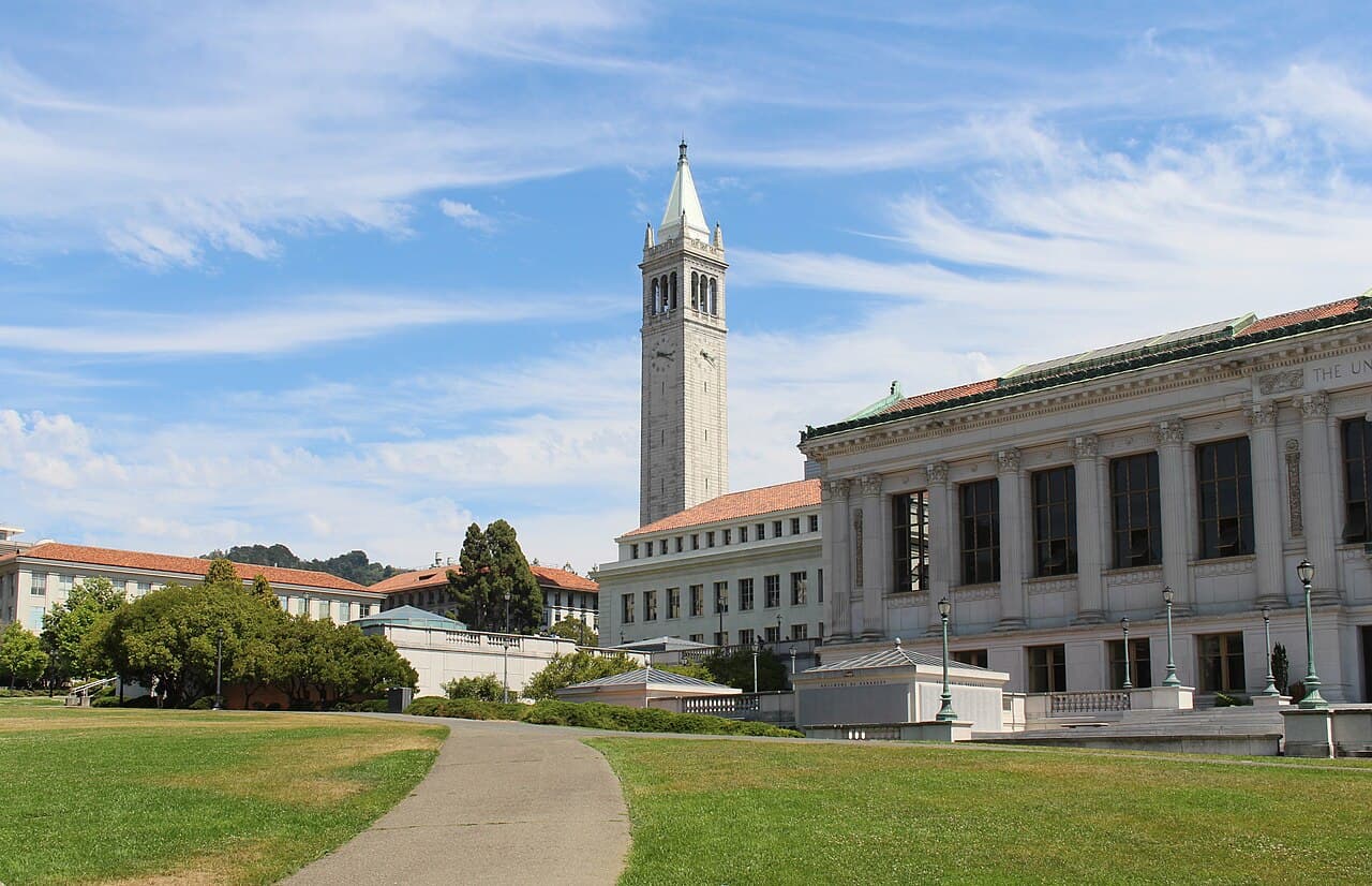 Sather Tower and Doe Library at UC Berkeley under a blue sky